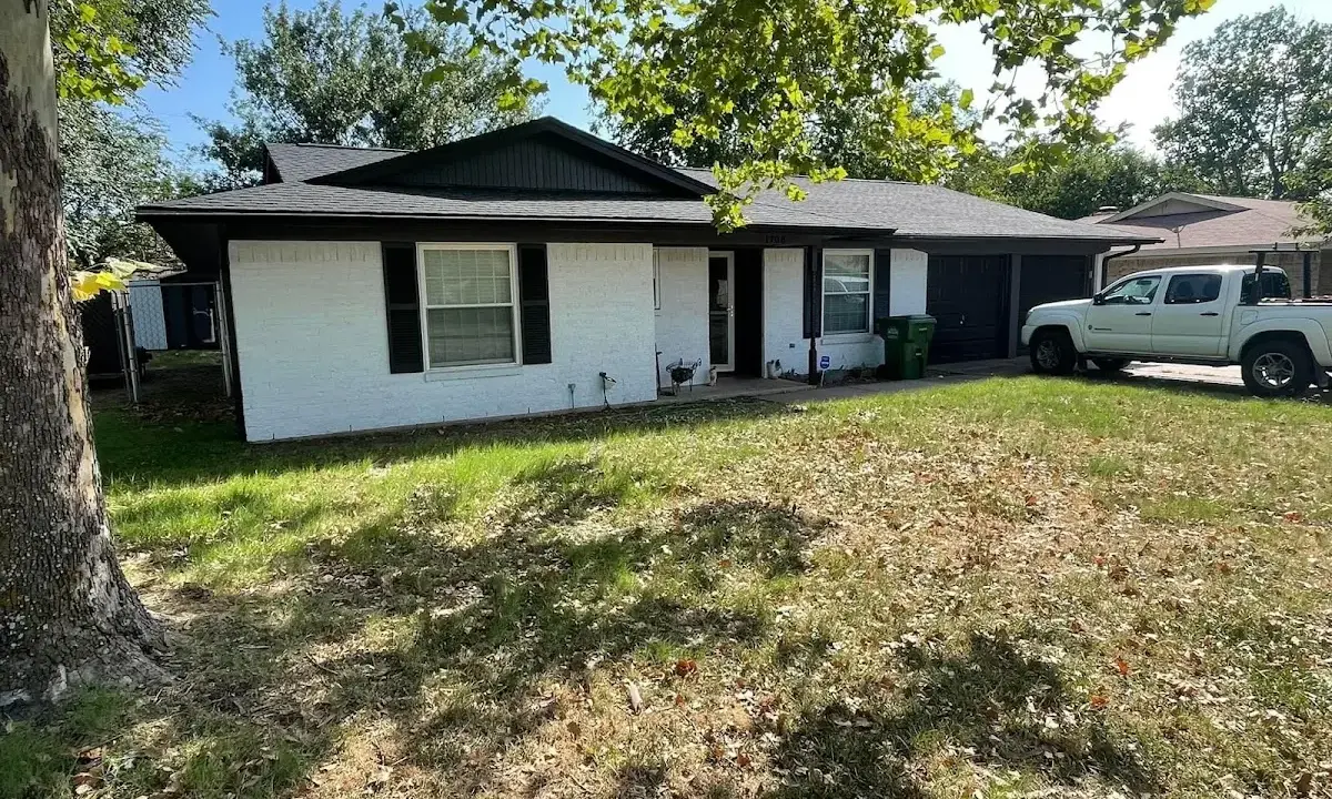 Professional roofing crew working on a residential roof in Clive